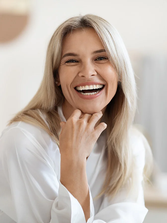 Happy mature woman with long gray hair smiling at camera in bright white shirt - Secret RF in Tampa, FL